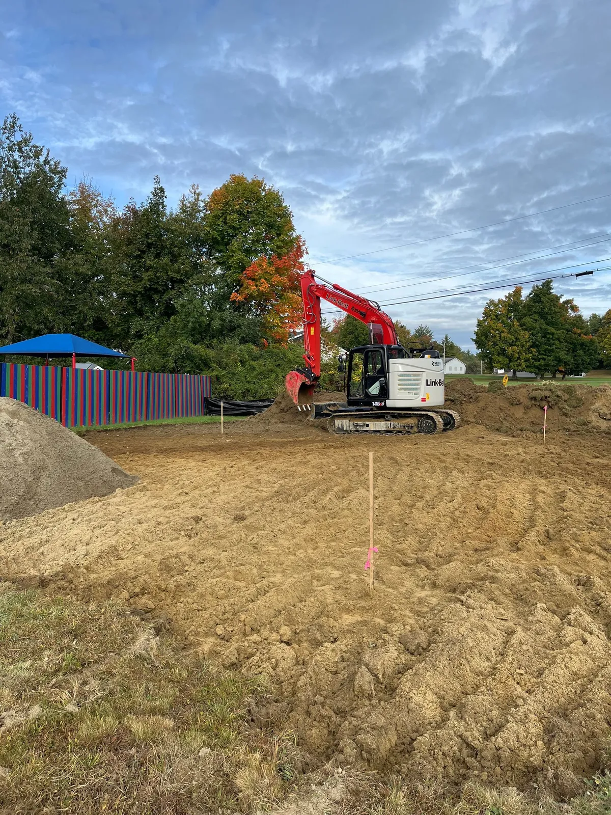 Equipment placing large stone along a bank.