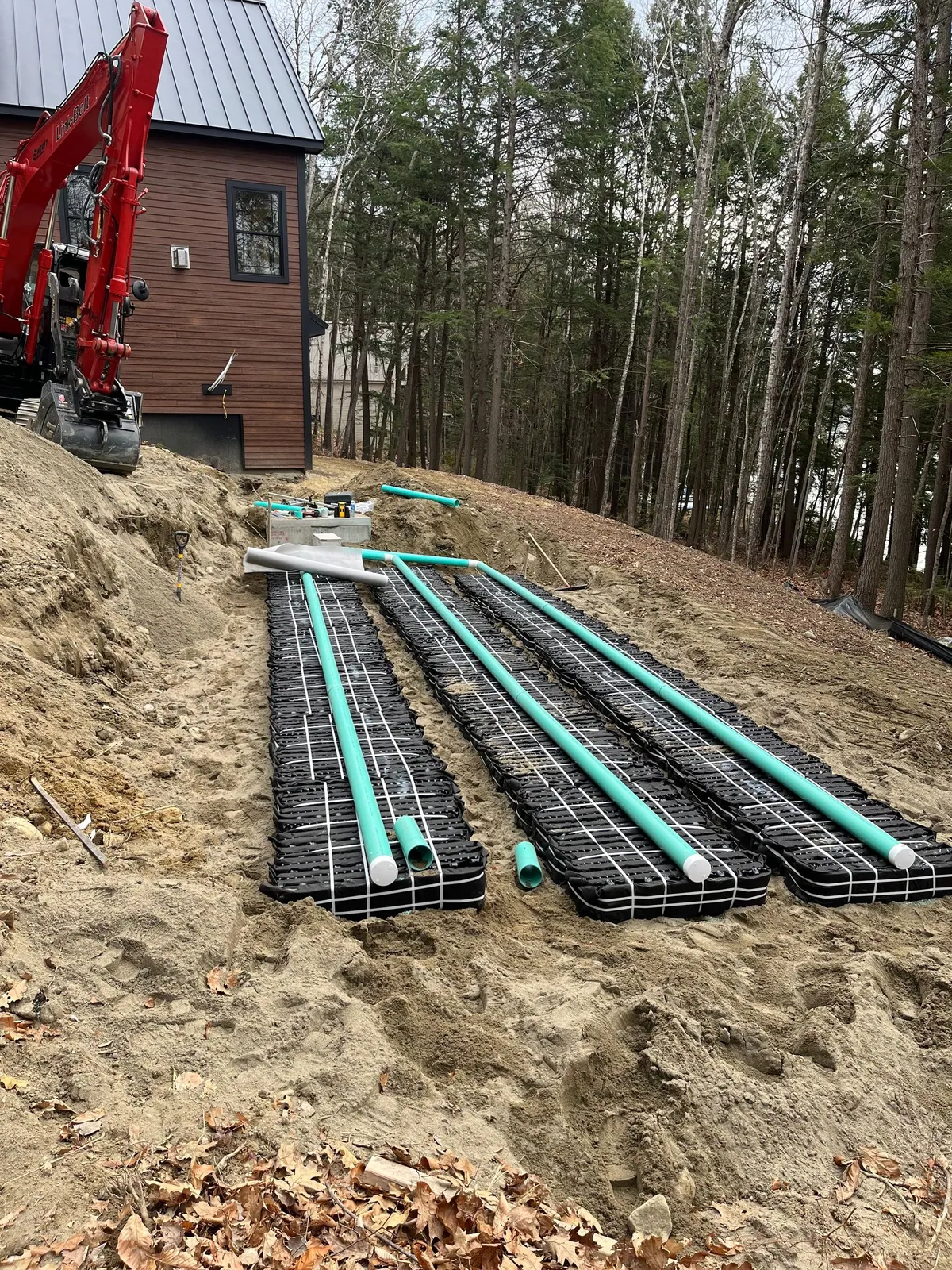 Site work photo showing graded ground and placed stone.