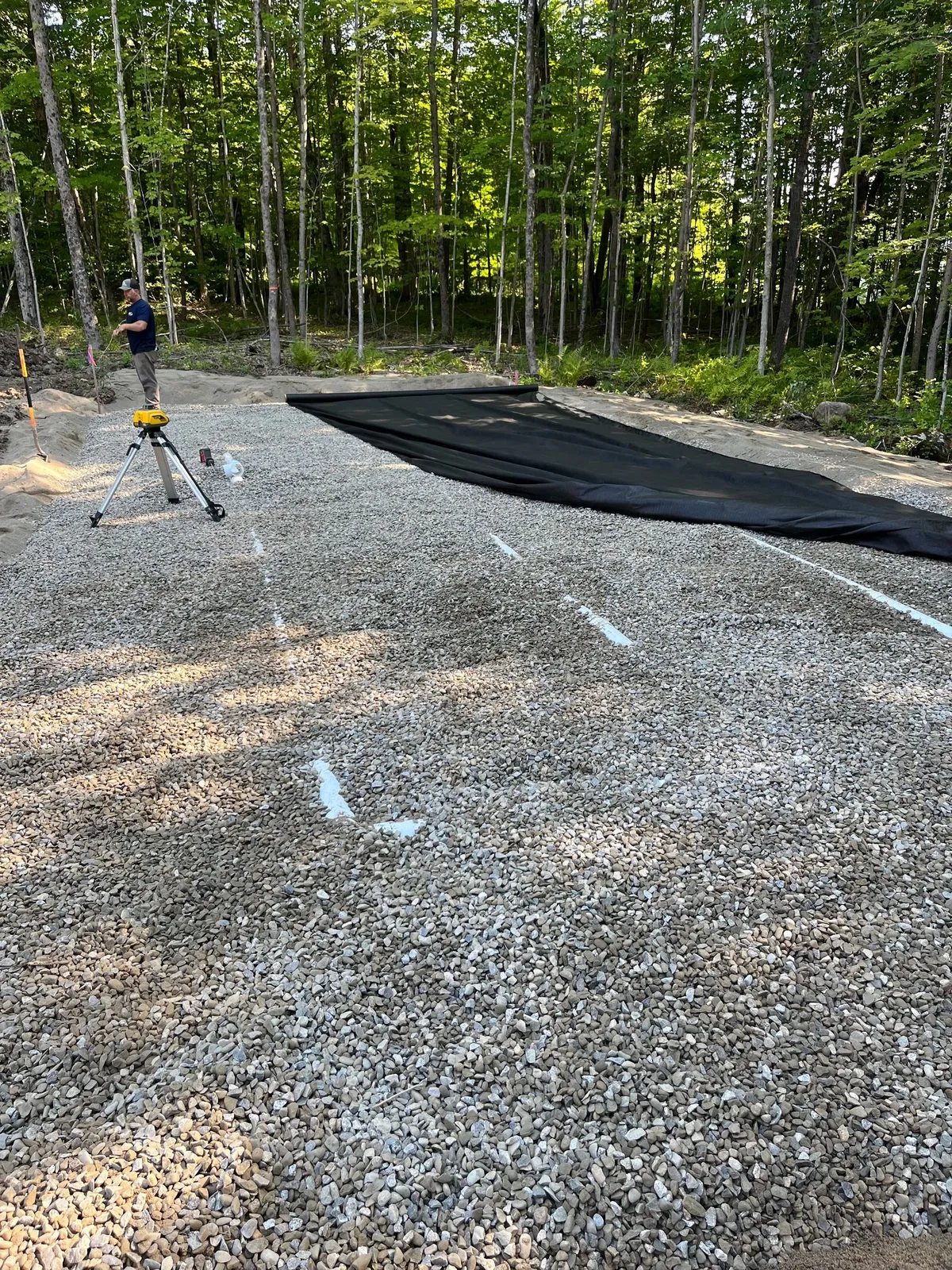A freshly graded gravel driveway on a rural Maine lot.